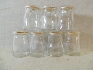 Seven Dairy Creamer Glass Bottles with Paper Lids