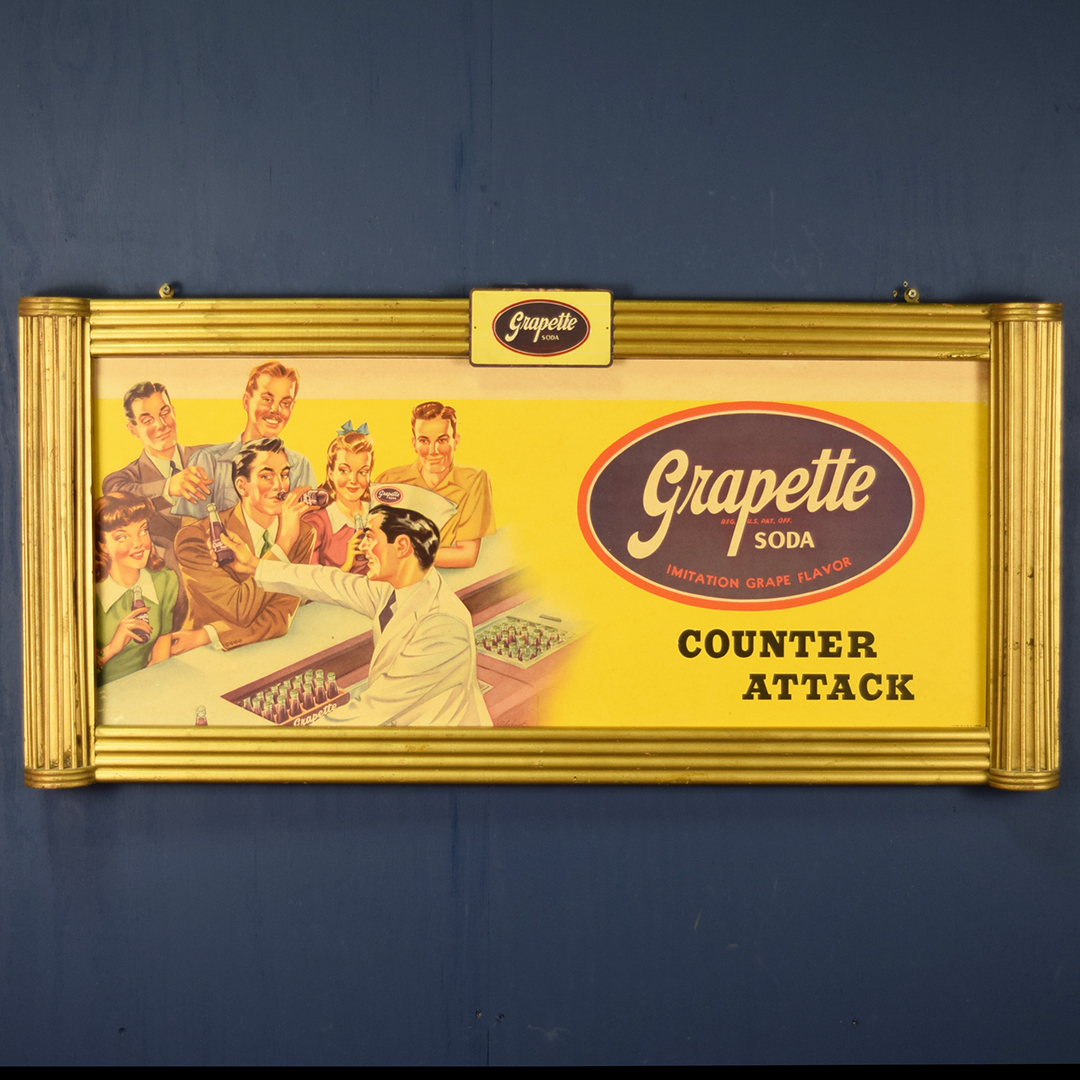 Grapette Soda "Counter Attack" Cardboard Sign & Wooden Frame